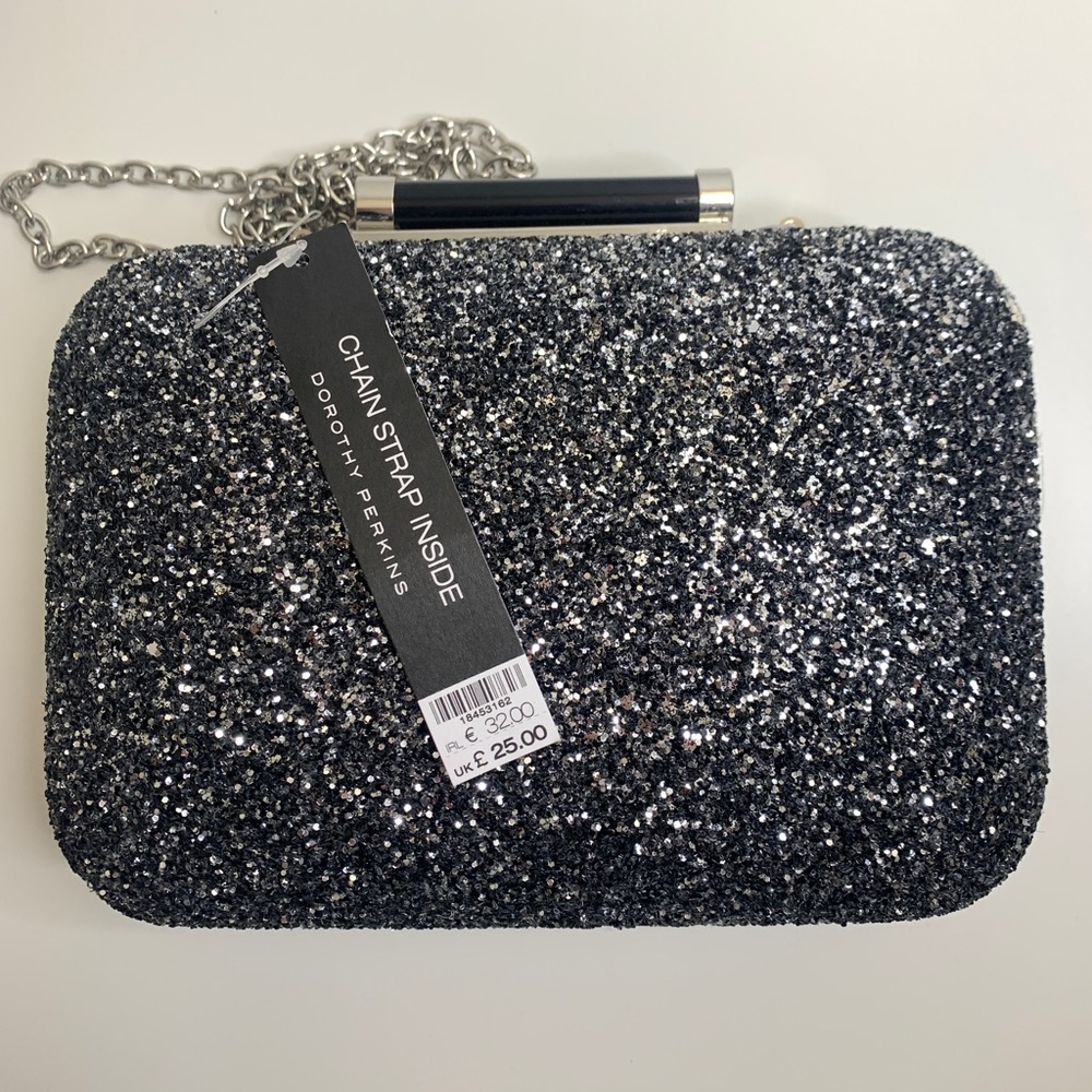 Black, silver glitter clutch. Chain can be easily removed. Hard shell.